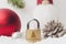 Coronavirus Christmas lockdown: a lock on the snow surrounded by christmas decorations and a Santa Claus puppy. Copy space