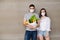 Coronavirus concept with couple, young man and woman in medical mask with food bag, fruits and vegetables