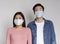 Coronavirus Concept. Frightened asian couple posing in protective medical masks