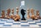 Coronavirus concept image chess pieces and hand sanitizer on chessboard