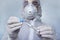 Coronavirus Covid-19 respiratory sputum specimen swab test tube with gloves, mask. specialist in a protective suit examines the
