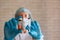 Coronavirus covid-19 vaccine vial and syringe in doctor`s hands, close up. Therapist in protective uniform in out of focus on the