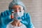 Coronavirus covid-19 vaccine vial and syringe in doctor`s hands, close up. Therapist in protective uniform in out of focus on the