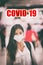 Coronavirus COVID-19 virus infection. Asian woman walking in airport crowd wearing virus surgical face mask with text