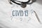 Coronavirus COVID name with questions and thermometer and stethoscope