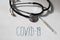 Coronavirus COVID name with questions and thermometer and stethoscope