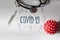 Coronavirus COVID red model with questions and thermometer and stethoscope