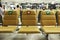 Coronavirus disease COVID-19 social distancing of passenger yellow chair in the airport.