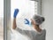 Coronavirus disinfection. People in making disinfection on windows. Doctor in rubber gloves disinfects windows with disinfectant
