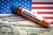 CORONAVIRUS ECONOMIC IMPACT text, US Dollar and blood sample vacuum tube on America flags background