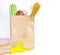 Coronavirus food supplies concept. Hends deliver brown paper bag with vagetables and pasta isolated on a white background. Copy