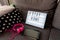 Coronavirus home lightbox sign with hashtag message  Stayhome glowing on home sofa with cozy. COVID-19 text to promote self