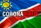 Coronavirus Monitor on Namibia flag background. Coronavirus hazard and Infection in Namibia concept. 3D rendering Corona virus