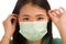 Coronavirus outbreak in China - young beautiful Asian Korean medicine doctor woman or hospital nurse in scrubs using protective