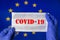 Coronavirus outbreak. Coronavirus update in Europe. Word Covid-19 on medical mask with flag of EU on background.