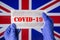 Coronavirus outbreak. Coronavirus update in Great Britain. Word Covid-19 on medical mask with UK flag on background.