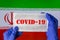 Coronavirus outbreak. Coronavirus update in Iran. Word Covid-19 on medical mask with iranian flag on background.