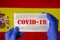 Coronavirus outbreak. Coronavirus update in Spain. Word Covid-19 on medical mask with spanish flag on background.