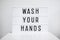 Coronavirus pandemic and hand hygiene concept - light box with wash your hands message