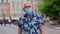 Coronavirus pandemic, portrait of senior stylish tourist man grandfather wearing protective mask