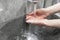 Coronavirus pandemic prevention. Washing hands with soap and warm water. Rubbing nails and fingers. Woman washing hand under runni