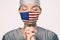 Coronavirus pandemic in the United States of America. USA american flag print on doctor`s mask praying with claspeds