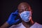 Coronavirus, portrait of a thoughtful african american man with protective mask and gloves