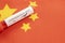 Coronavirus positive test on blood collection tubes on Chinese flag - concept of virus found in China