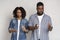 Coronavirus Precautions. Black couple applying disinfectant antibacterial spray on hands