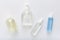 Coronavirus protection hand hygiene. Many hand sanitizer bottles on white table. Alcohol gel antibacterial soap sanitizer, hands