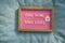 Coronavirus quote stay home, save lives pink felt board sign with message of self isolation for social responsability on