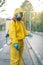 Coronavirus. A sanitation worker wearing a mask and cleaning the streets. Sterilize urban decontaminate city. Disinfecting against