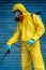 Coronavirus. A sanitation worker wearing a mask and cleaning the streets. Sterilize urban decontaminate city. Disinfecting against