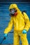 Coronavirus. A sanitation worker wearing a mask and cleaning the streets. Sterilize urban decontaminate city. Disinfecting against