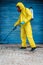 Coronavirus. A sanitation worker wearing a mask and cleaning the streets. Sterilize urban decontaminate city. Disinfecting against