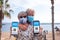 Coronavirus. Senior couple travelers in vacation at sea shows mobile app with certificate of vaccination of Covid-19