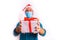 Coronavirus shopping christmas concept. young man with santa claus hat and face mask and gifts in studio with red background,