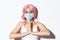 Coronavirus, social distancing and lifestyle concept. Close-up of thankful girl in medical mask and pink wig, clasp