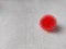 Coronavirus symbol on white textured table, rubber bowl with red spikes in the shape of a coronavirus virus