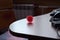 Coronavirus symbol on white textured table, rubber bowl with red spikes in the shape of a coronavirus virus, red ball for massage