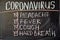 Coronavirus symptoms. Outbreak Warning. written white chalk on blackboard in connection with epidemic of coronavirus worldwide