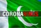 Coronavirus Text on Pakistan flag background. Coronavirus hazard and Infection in Pakistan concept. 3D rendering Corona virus