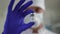 Coronavirus vaccine ampoule in hand of blurred doctor close-up. Unrecognizable Caucasian medical worker showing Covid-19