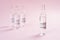 Coronavirus vaccine. Glass ampoules with a medicine for COVID-19 on a pink background