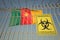 Coronavirus warning sign on the fence on the Cameroonian flag background. Quarantine in Cameroon, conceptual 3D