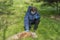 Coronavirus. A woman in a mask and blue rubber gloves near a dead dog on the grass during a coronavirus, The death of an animal