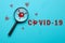 Coronovirus covid-19 answers and questions concept - magnifier with virus sign on blue background