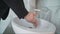 Coronovirus Prevention. A man washes his hands thoroughly in the sink. A man pours liquid soap into his hand. Water pours from the