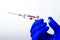 Coronovirus vaccine in syringe. The new vaccine is ready.Close-up of the liquid drop at the end of the needle