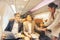 On a corporate aircraft, an air hostess serves passengers. On an airplane, a flight attendant serves a drink to a businessman who